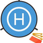 Foldable blue drone landing pad with white 'H' symbol, shown with yellow stakes and orange reflector for nighttime visibility