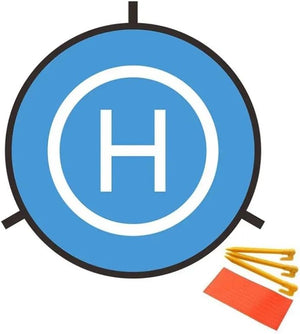 Foldable blue drone landing pad with white 'H' symbol, shown with yellow stakes and orange reflector for nighttime visibility