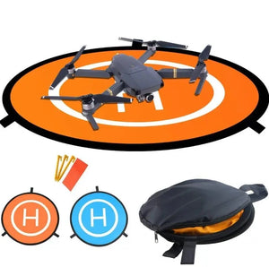 Foldable orange drone landing pad in use with quadcopter drone, includes accessories like stakes and carry pouch